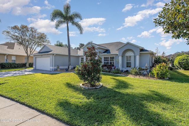 ranch-style house featuring a garage and a front lawn