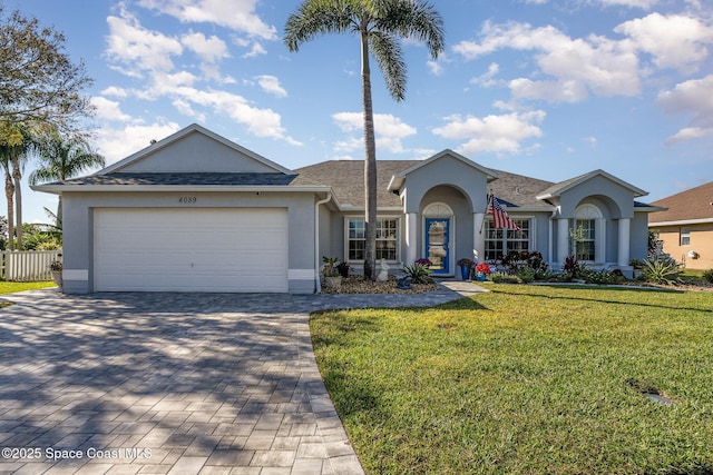 single story home featuring a garage and a front lawn