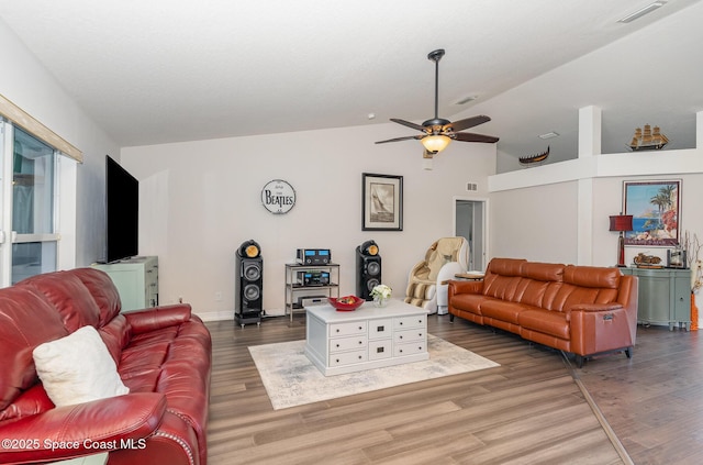 living room with vaulted ceiling, ceiling fan, and dark hardwood / wood-style flooring