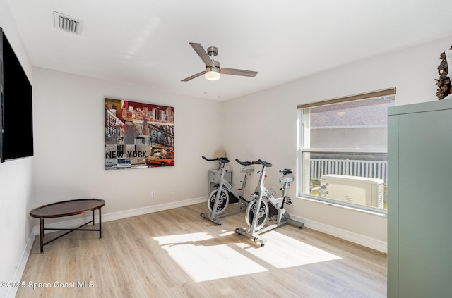 workout room with light hardwood / wood-style flooring and ceiling fan