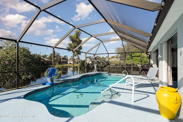 view of swimming pool featuring glass enclosure, a water view, and a patio area