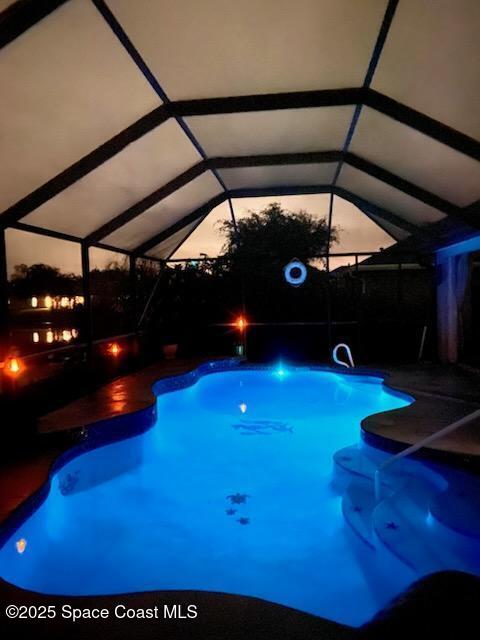 pool at dusk with glass enclosure