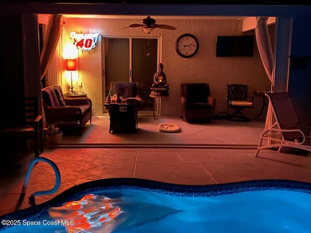 view of pool featuring ceiling fan