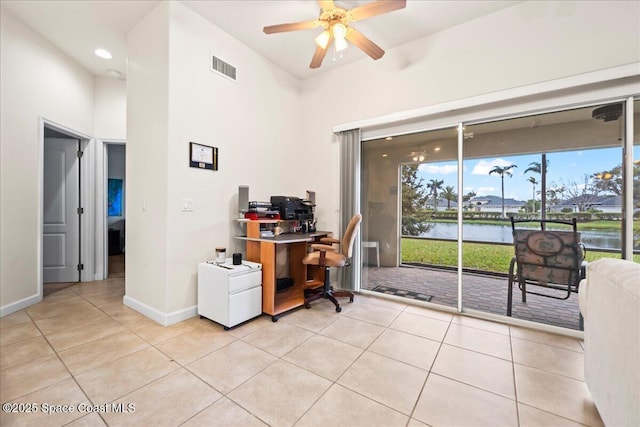 office area featuring light tile patterned flooring, a water view, and ceiling fan