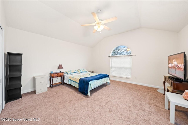 bedroom with ceiling fan, lofted ceiling, and carpet