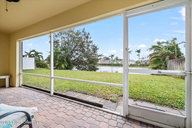 unfurnished sunroom with a water view