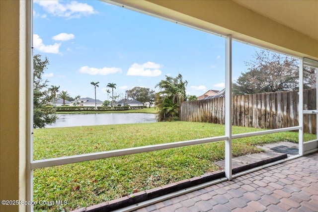 unfurnished sunroom featuring a water view and plenty of natural light