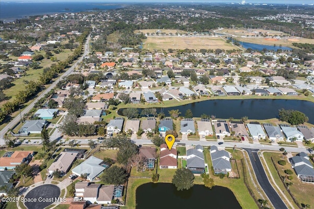 birds eye view of property with a water view