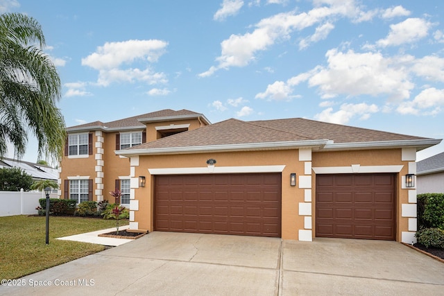 prairie-style home with a garage and a front lawn