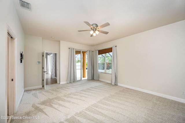 unfurnished room featuring ceiling fan and light carpet