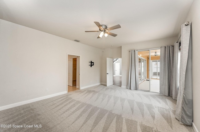 empty room featuring ceiling fan and light colored carpet