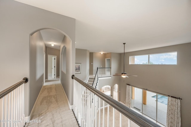 hall featuring light colored carpet