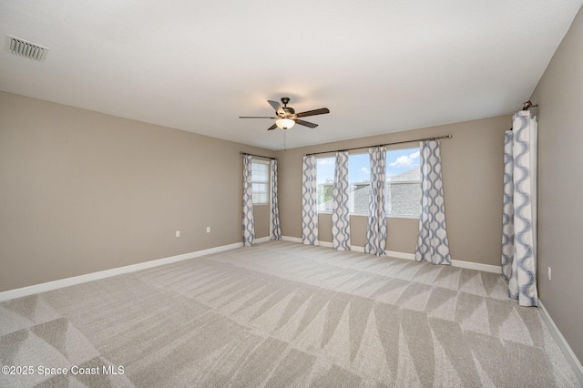 empty room featuring light carpet and ceiling fan