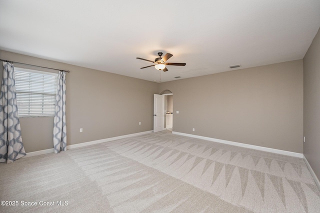 carpeted spare room featuring ceiling fan