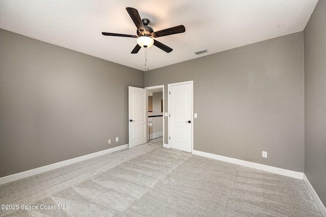 unfurnished bedroom featuring ceiling fan and light carpet