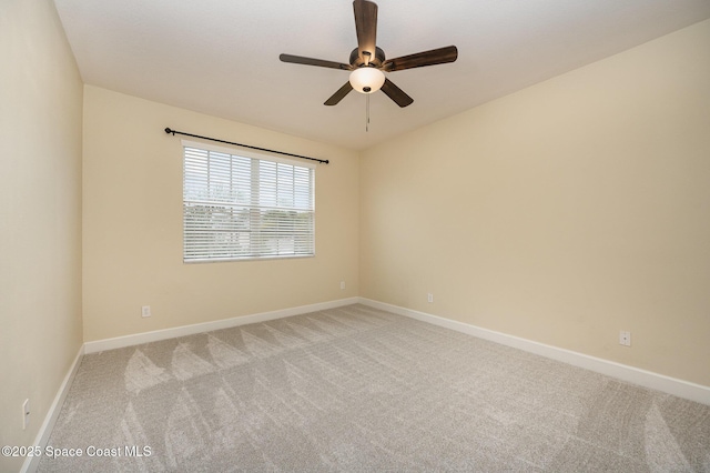 empty room featuring ceiling fan and light colored carpet