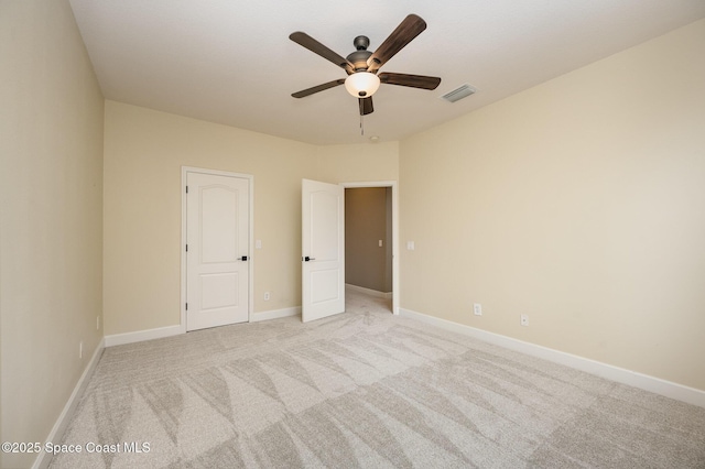 carpeted spare room with ceiling fan