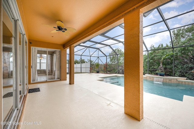 view of pool with ceiling fan, a patio area, a lanai, and pool water feature