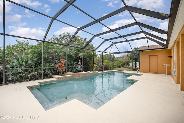 view of pool with a patio and a lanai