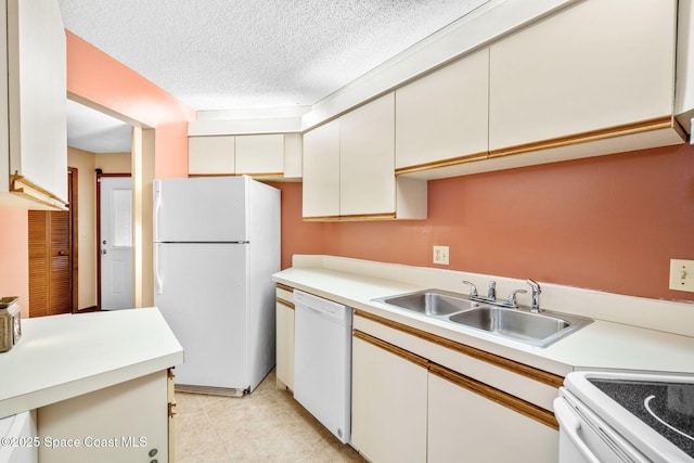 kitchen with white cabinetry, white appliances, sink, and a textured ceiling