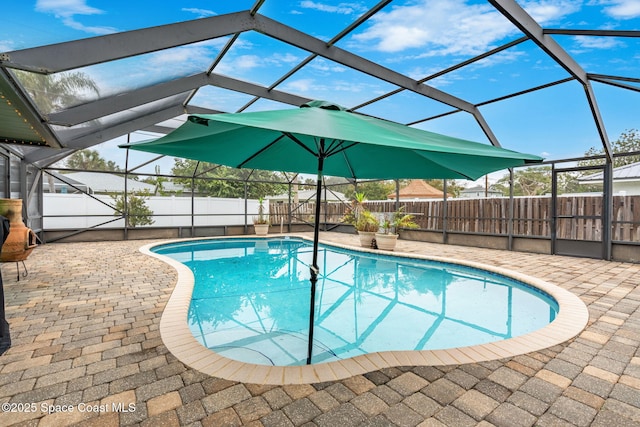 view of pool featuring a patio and glass enclosure