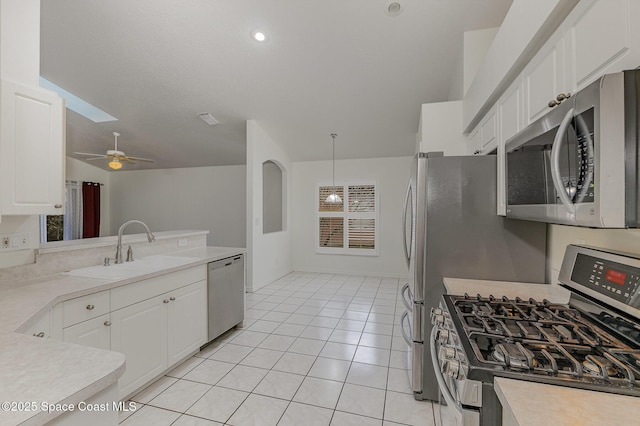 kitchen featuring sink, white cabinets, ceiling fan, pendant lighting, and appliances with stainless steel finishes