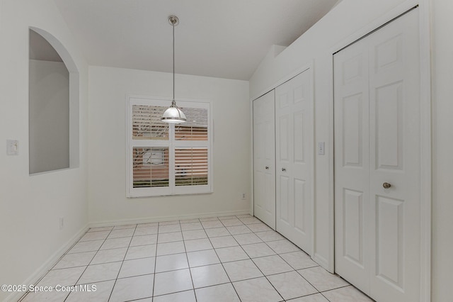 unfurnished dining area featuring light tile patterned floors