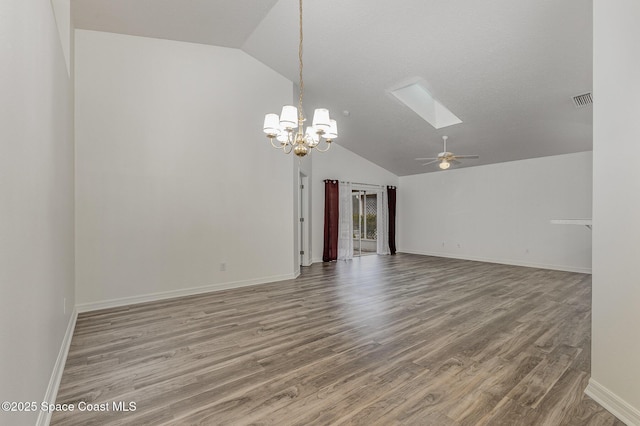 spare room with lofted ceiling with skylight, ceiling fan with notable chandelier, and hardwood / wood-style flooring