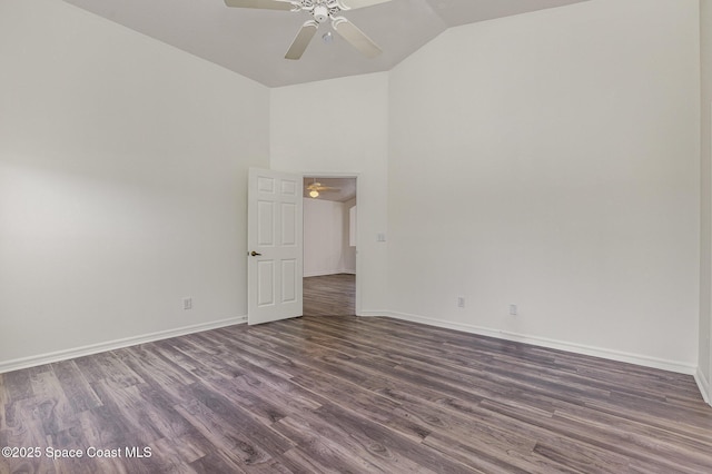 empty room featuring ceiling fan, vaulted ceiling, and dark wood-type flooring