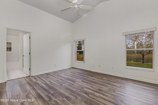 unfurnished room featuring wood-type flooring, high vaulted ceiling, and ceiling fan