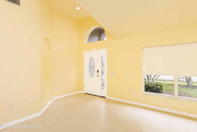 foyer featuring a towering ceiling