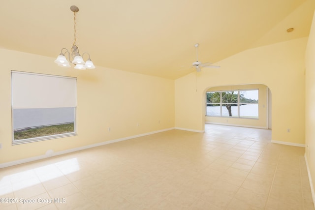 spare room with ceiling fan with notable chandelier, light tile patterned flooring, vaulted ceiling, and a water view