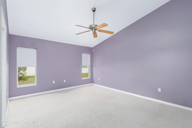 unfurnished room with lofted ceiling, ceiling fan, and carpet flooring