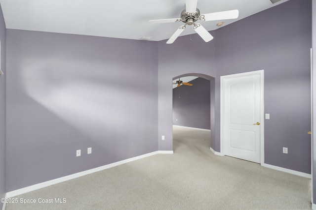 carpeted spare room with ceiling fan