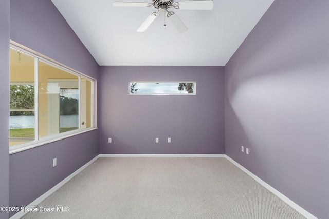 unfurnished room featuring lofted ceiling, carpet floors, and ceiling fan