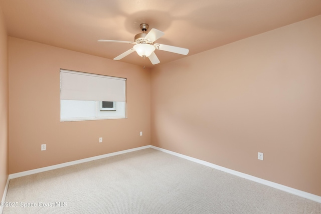 empty room featuring ceiling fan and carpet