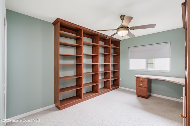 home office featuring ceiling fan and light colored carpet