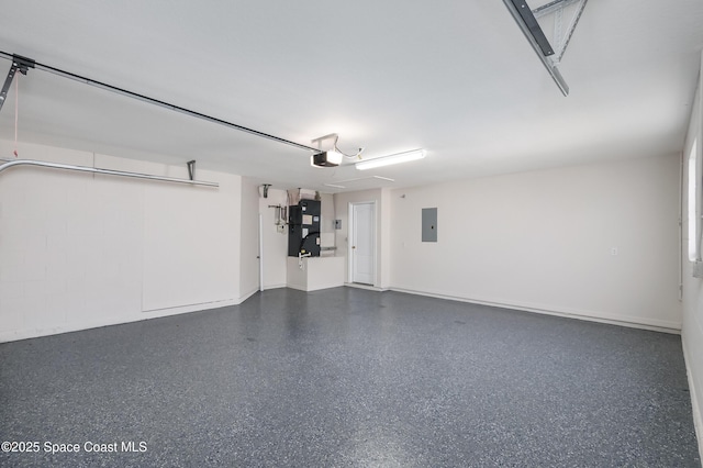 garage featuring a garage door opener, heating unit, and electric panel