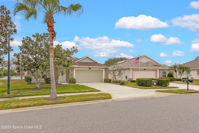 view of front of property with a front yard and a garage