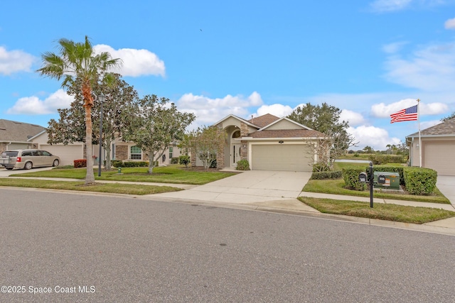 view of front of property featuring a garage and a front yard