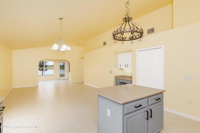 kitchen with a center island, vaulted ceiling, and hanging light fixtures