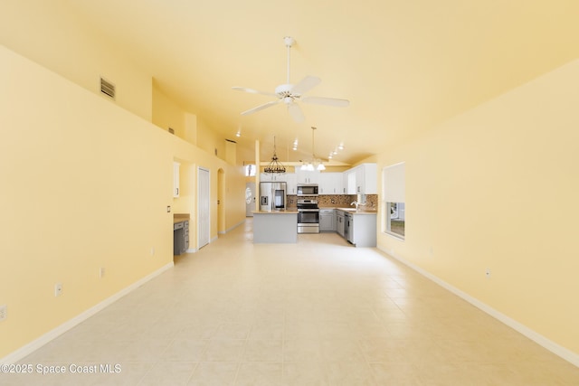 unfurnished living room featuring ceiling fan, high vaulted ceiling, and sink