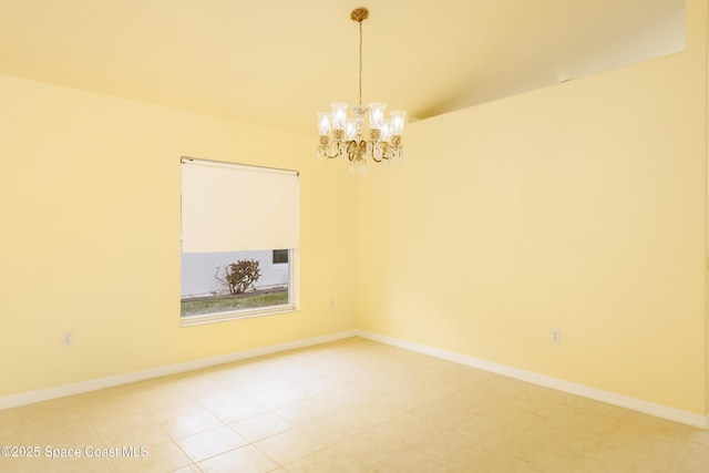 unfurnished room with tile patterned flooring and a chandelier