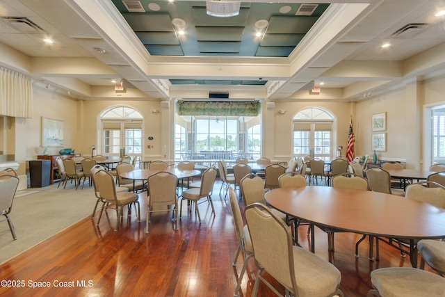 dining room with a high ceiling, a wealth of natural light, and dark hardwood / wood-style floors