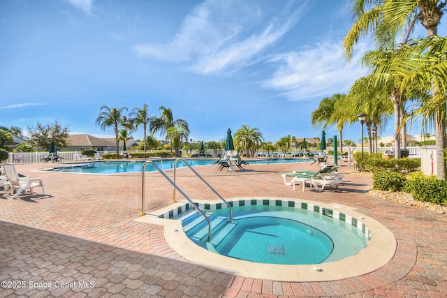 view of pool with a community hot tub and a patio area