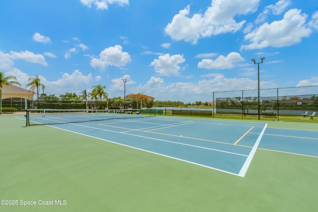 view of tennis court with basketball hoop