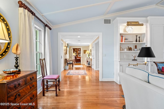 hallway with lofted ceiling, light hardwood / wood-style floors, and crown molding