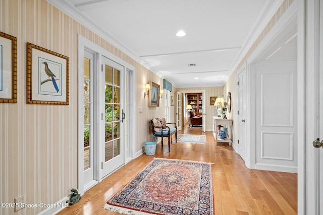 doorway featuring light wood-type flooring, french doors, and crown molding