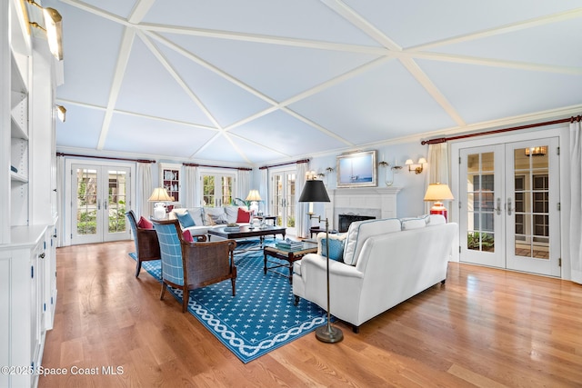 living room with french doors, ornamental molding, and hardwood / wood-style flooring