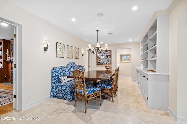 dining space featuring ornamental molding, a chandelier, and built in shelves